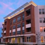 aluminum cantilevered sunshades on the top of a 3-story building