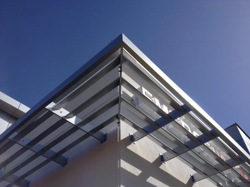 Close-up of aluminum sunshade blades at the corner of a building