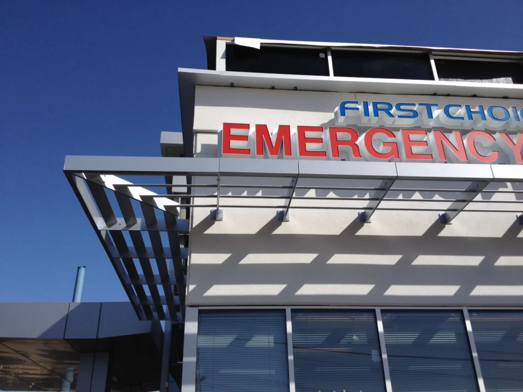 Aluminum sunshades under the sign of a First Choice Emergency Room