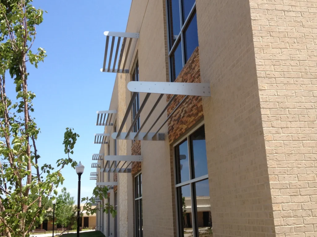 Side view of aluminum sunshades projecting from a stone building
