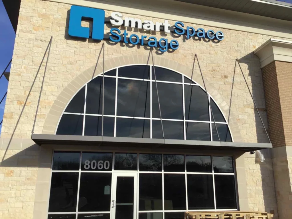 Hanger-rod-supported aluminum canopy over the entrance of a self-storage facility